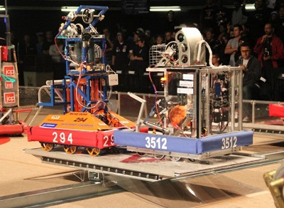 Beach Cities Robotics’ 294 (left) eyes up its competition at a 2012 competition.