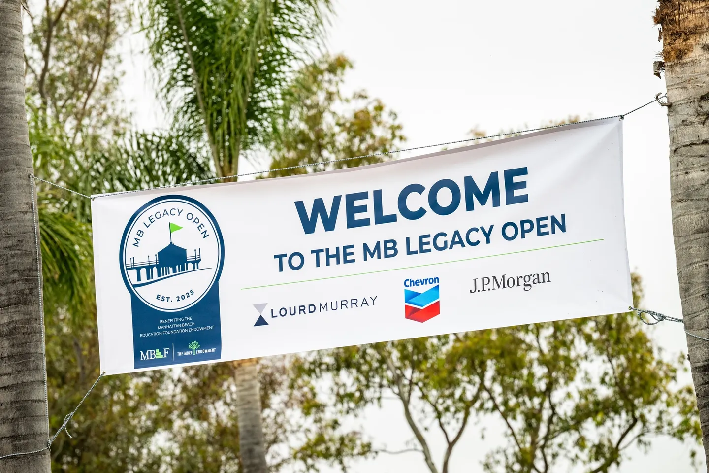 Banner welcoming attendees to the MB Legacy Open.
